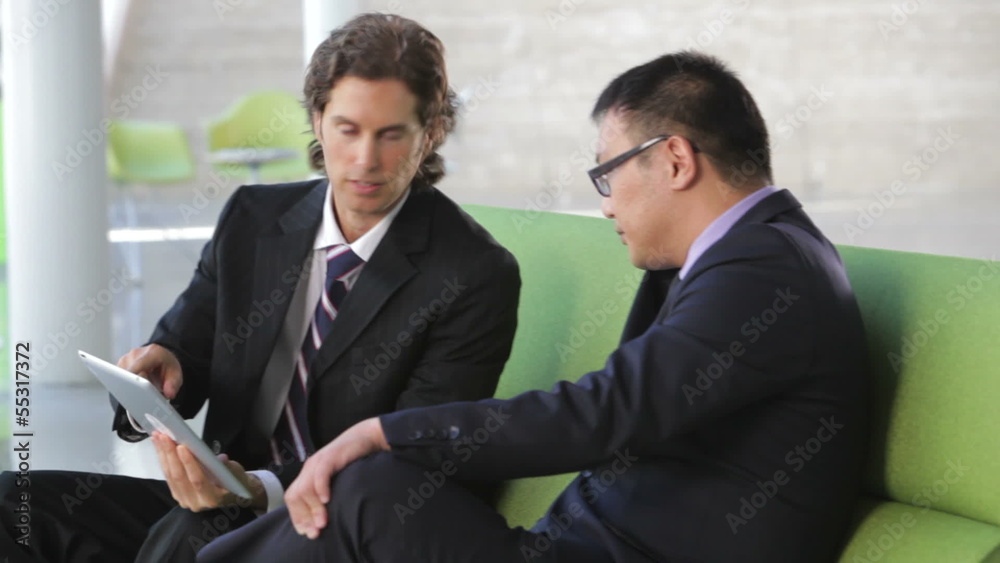 Businessmen On Sofa And Using Digital Tablet