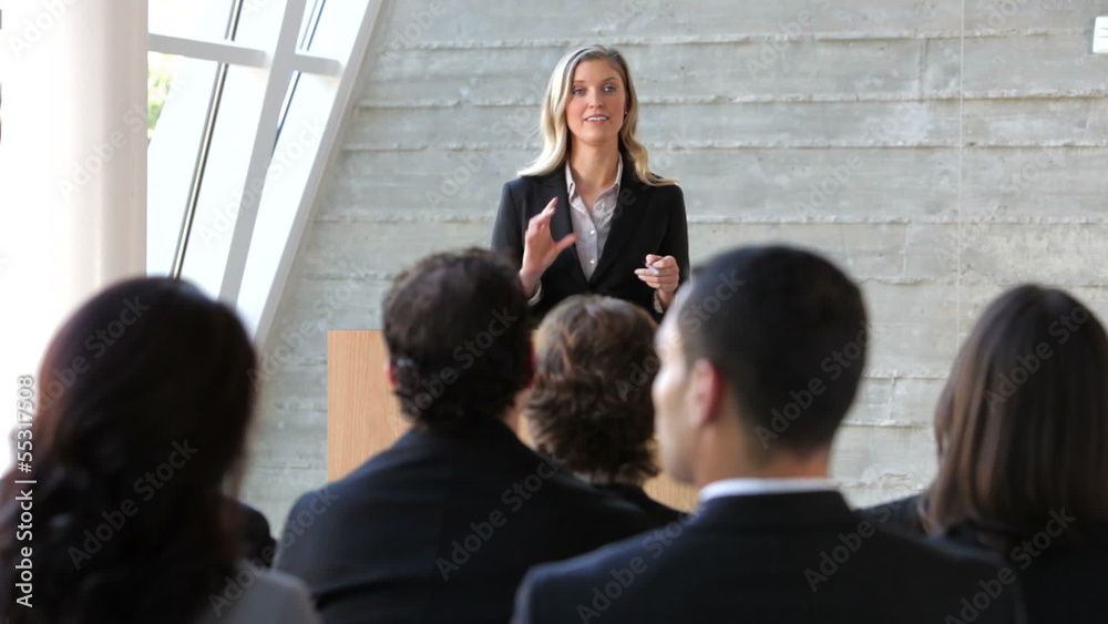 Businesswoman Giving Presentation At Conference Businesswoman Giving Presentation At Conference