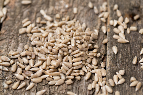 peeled sunflower seeds on wooden surface