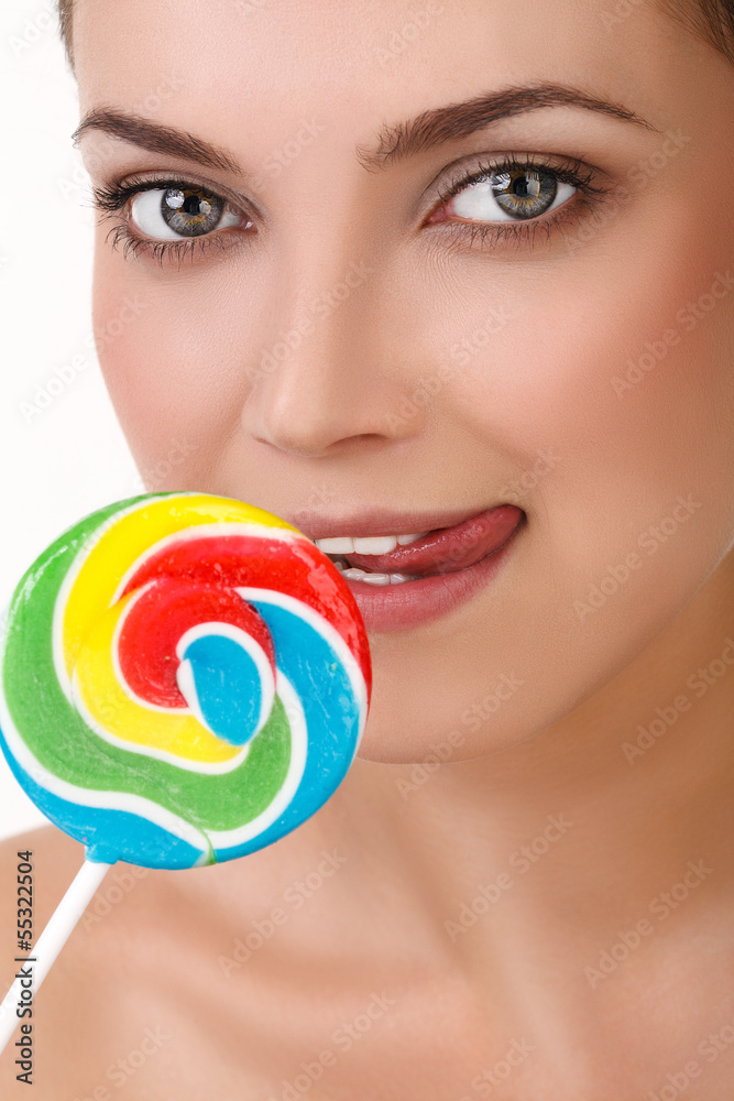 Young girl with a lollipop near her lips