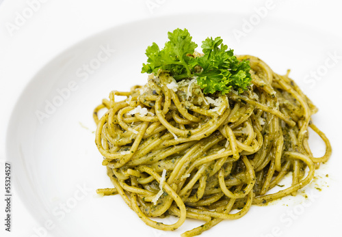 Italian pasta spaghetti with pesto sauce and basil leaf