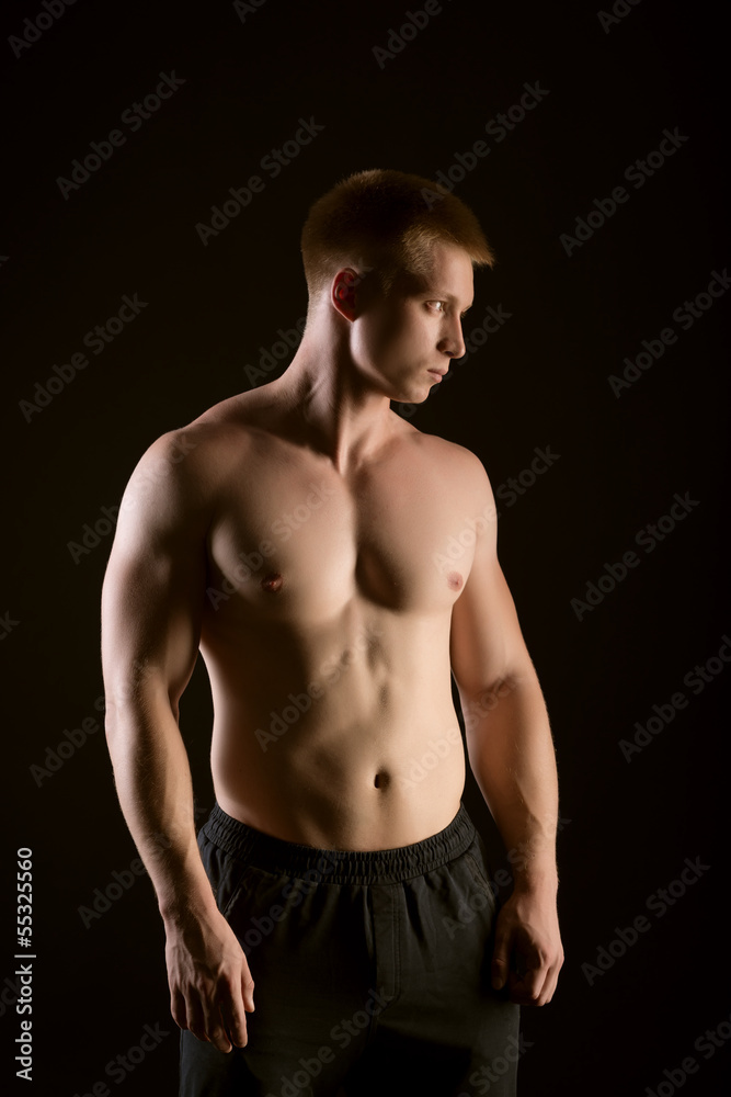 Healthy muscular young man posing in studio Healthy muscular young man posing in studio