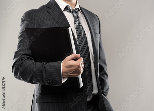 Confident businessman holding a black folder