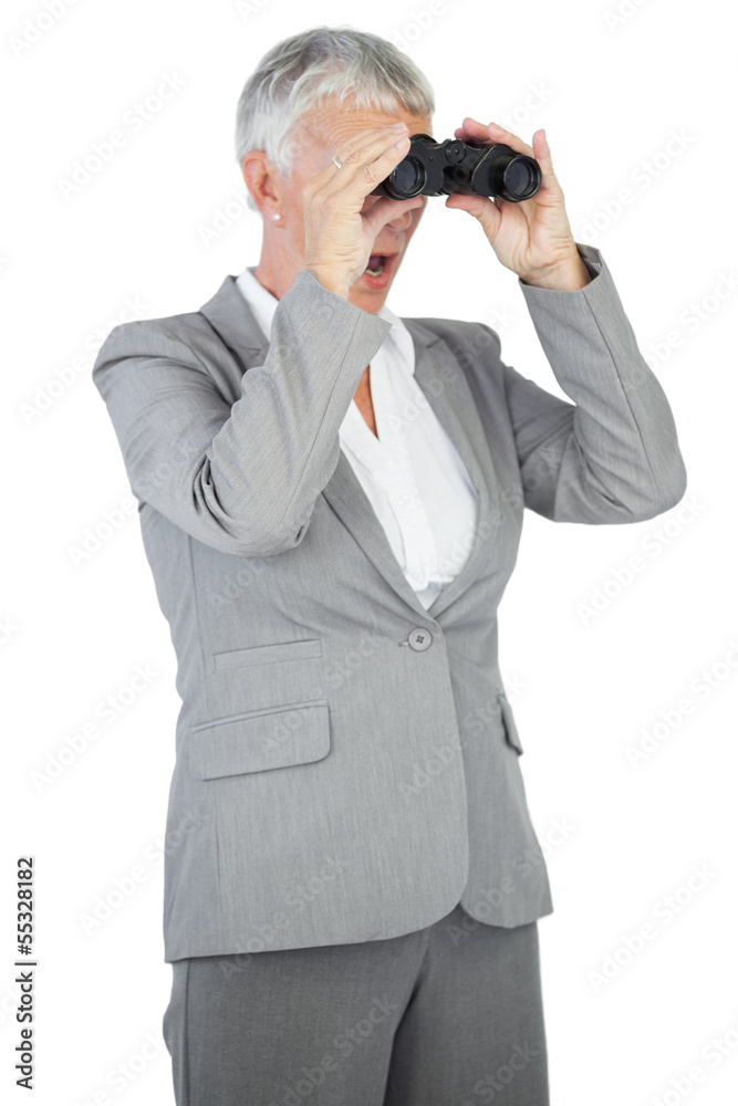 Businesswoman looking at something through binoculars Businesswoman looking at something through binoculars