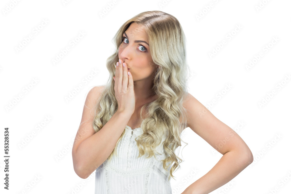 Seductive model in white dress posing hand on her mouth Seductive model in white dress posing hand on her mouth