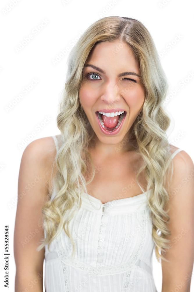 Cheerful blue eyed model winking at camera Cheerful blue eyed model winking at camera