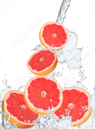 Fresh grapefruits falling in water splash, 