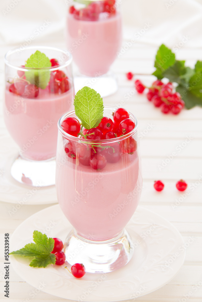 Panna cotta dessert with red currants, selective focus. Panna cotta dessert with red currants, selective focus.