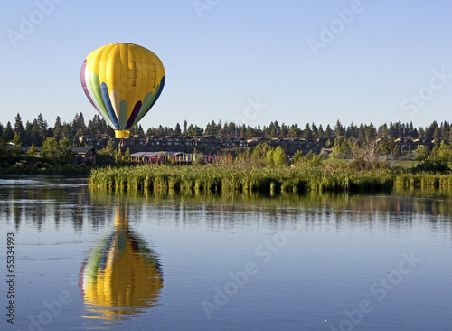 Yellow hot air balloon reflected in The Deschutes River, Oregon