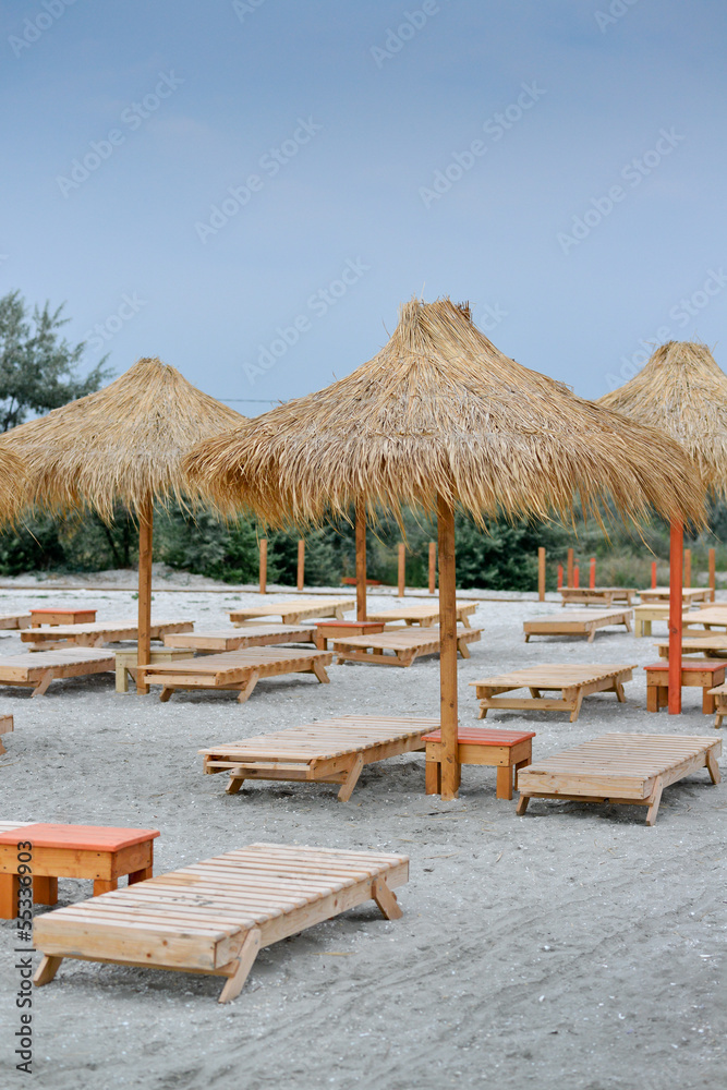 Fototapeta premium Many sunbeds on tropical beach.
