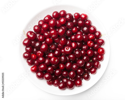 sour cherries on a plate, isolated on white