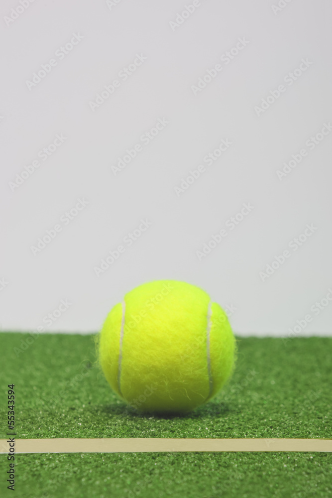 Tennis composition. Yellow ball, line and green grass court