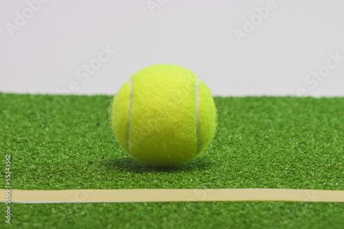 Tennis composition. Yellow ball, line and green grass court © danmorgan12