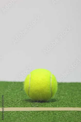 Tennis composition. Yellow ball, line and green grass court