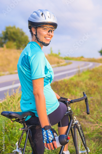 Portrait of young smiling happy female caucasian cyclist athlete