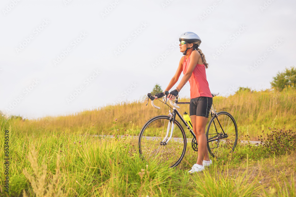 portrait of a young female sport athlete with racing bike restin portrait of a young female sport athlete with racing bike restin