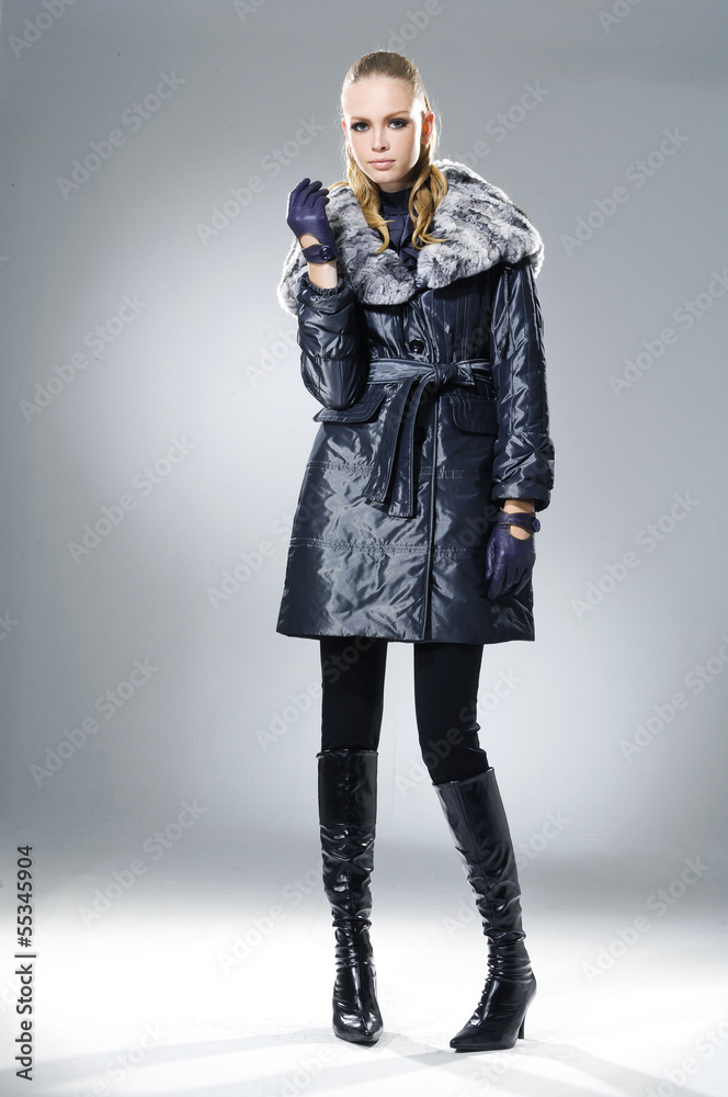 High fashion model in fashion dress posing on gray background High fashion model in fashion dress posing on gray background