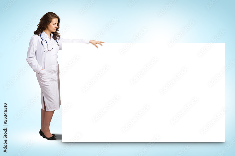 young woman doctor standing near a blank banner young woman doctor standing near a blank banner
