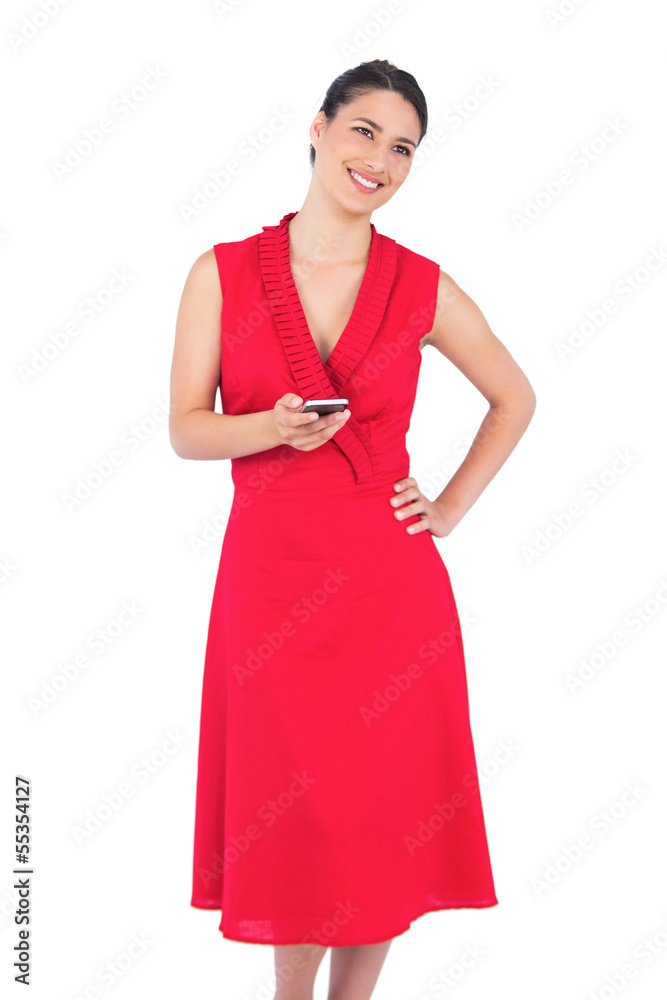 Happy elegant brunette in red dress texting Happy elegant brunette in red dress texting