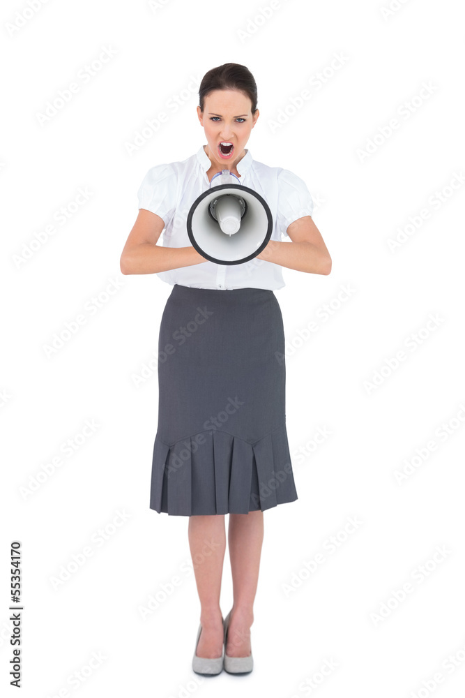 Angry businesswoman shouting in her megaphone Angry businesswoman shouting in her megaphone