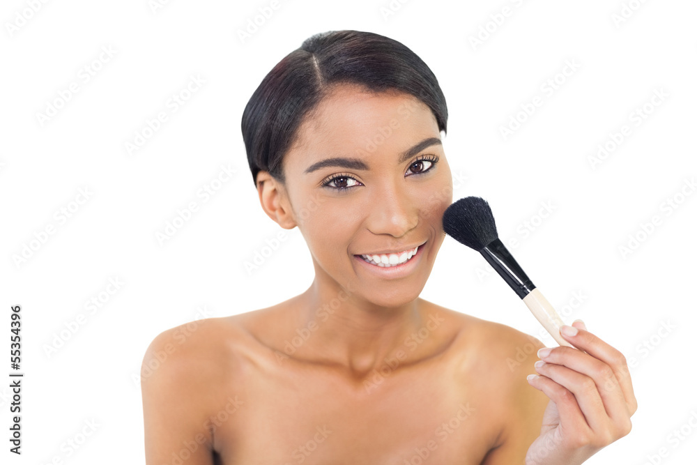 Smiling natural model using blusher brush Smiling natural model using blusher brush