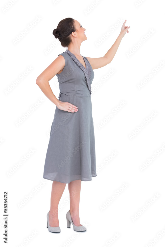 Smiling gorgeous woman in classy dress pointing out direction Smiling gorgeous woman in classy dress pointing out direction