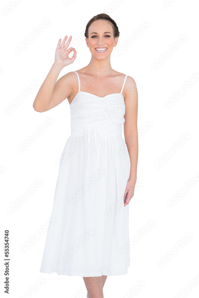 Smiling young model making an okay gesture Smiling young model making an okay gesture