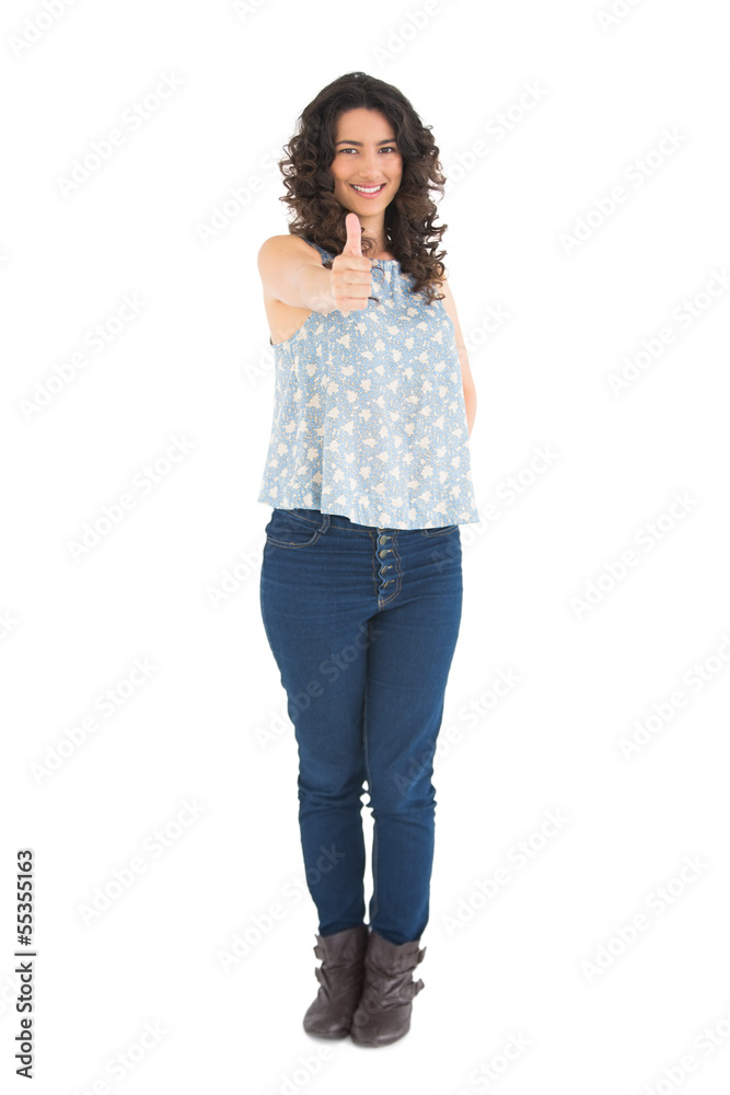 Smiling attractive brunette posing thumbs up Smiling attractive brunette posing thumbs up