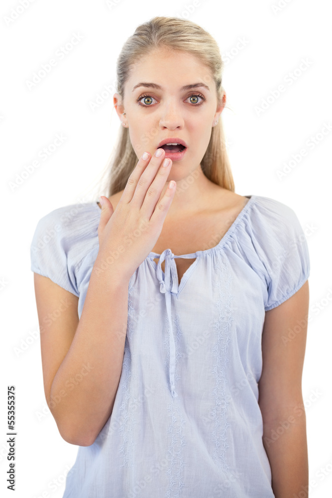 Shocked blonde woman with hand in front of her mouth Shocked blonde woman with hand in front of her mouth
