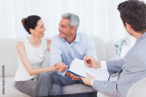 Couple speaking while salesman is holding contract © WavebreakmediaMicro