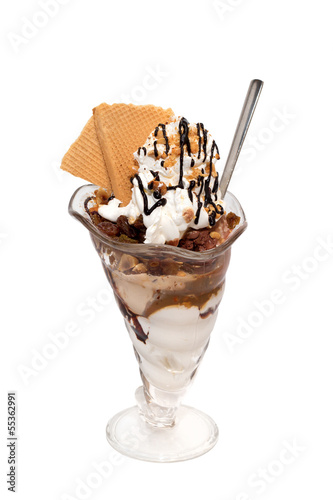 Ice cream cup with cream, topping and cookies isolated
