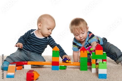 Two baby boys are playing