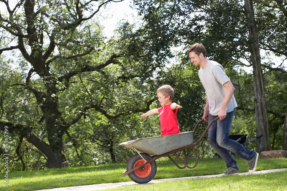 Father Giving Son Ride In Wheelbarrow Father Giving Son Ride In Wheelbarrow