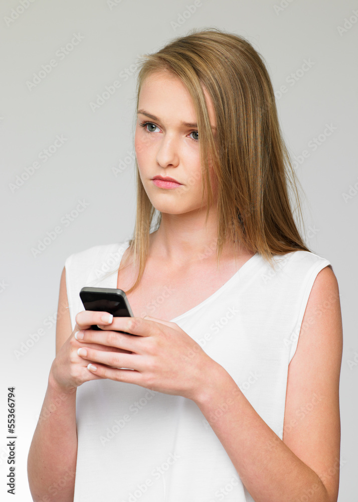 Teenage Girl Being Bullied By Text Message On Mobile Phone Teenage Girl Being Bullied By Text Message On Mobile Phone