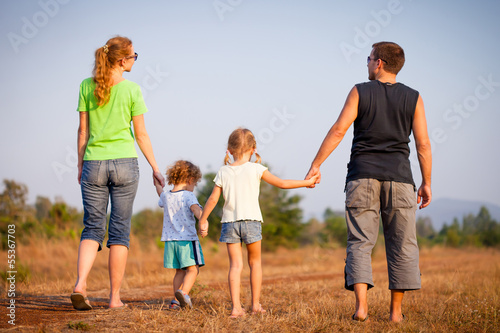 happy family walking on the road