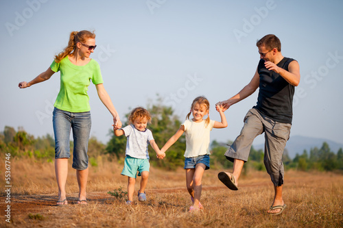 happy family walking on the road