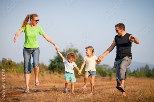 happy family walking on the road