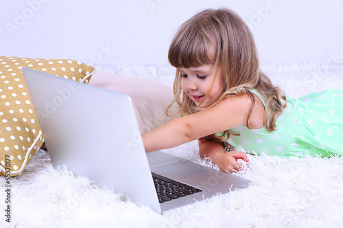 Little cute girl lies on ca...