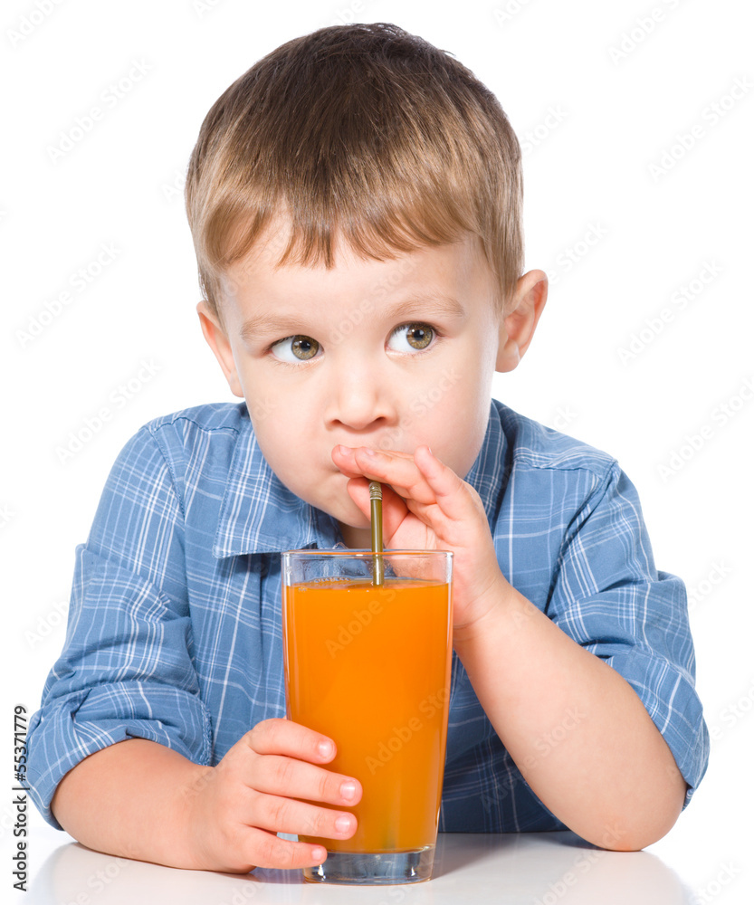 Little boy with glass of carrot juice Little boy with glass of carrot juice