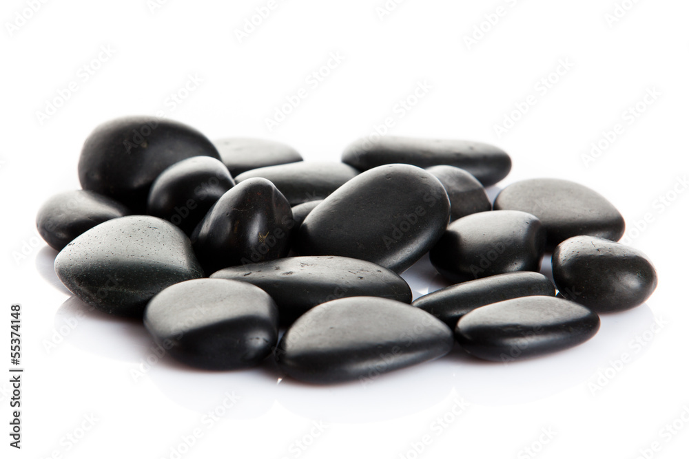 Black massage stones isolated.