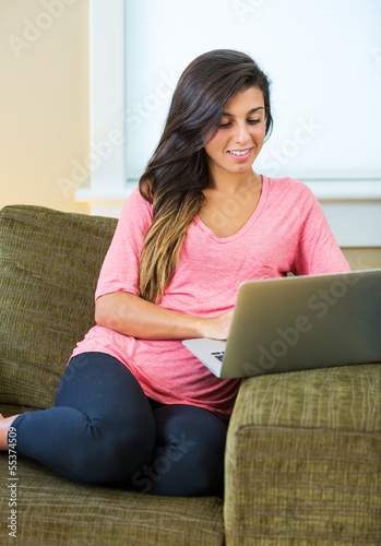 Free Download happy young woman using a laptop computer - GFXLoad