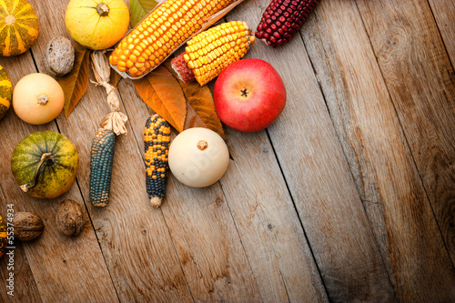 Fototapeta Naklejka Na Ścianę i Meble -  Harvest on a table - corn, apple and pumpkin