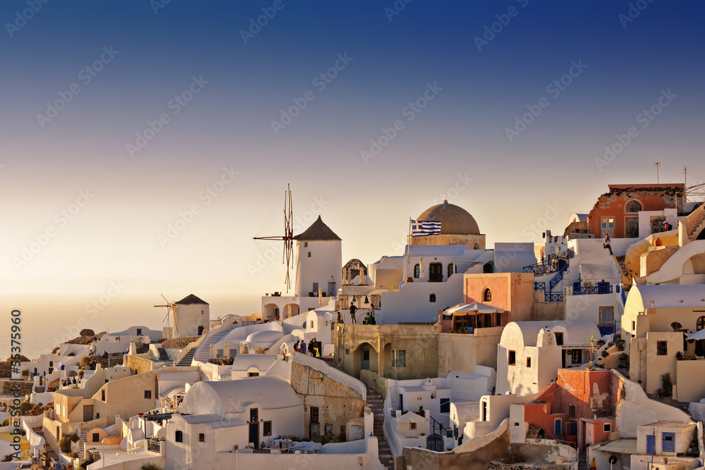 Oia white houses and windmills at sunset