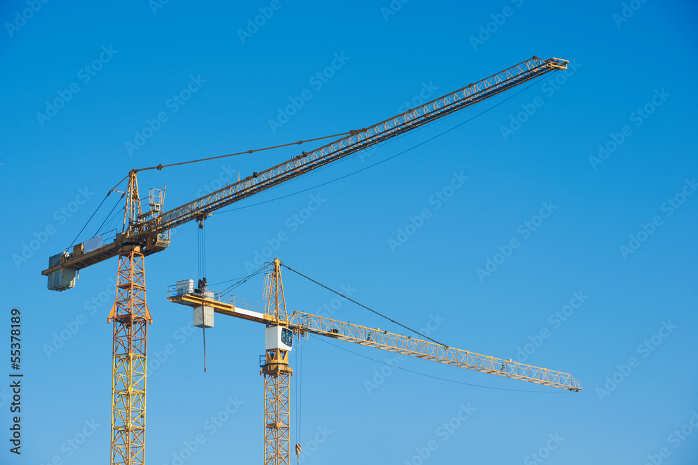 tower cranes over blue sky