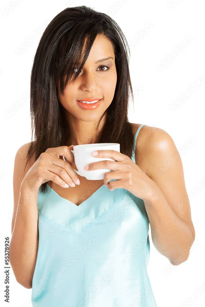 Attractive woman in nightwear drinking from cup Attractive woman in nightwear drinking from cup