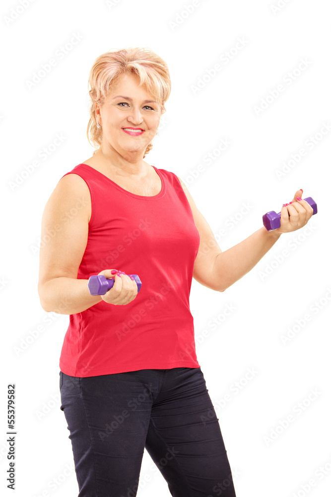 Mature smiling woman lifting up weights Mature smiling woman lifting up weights