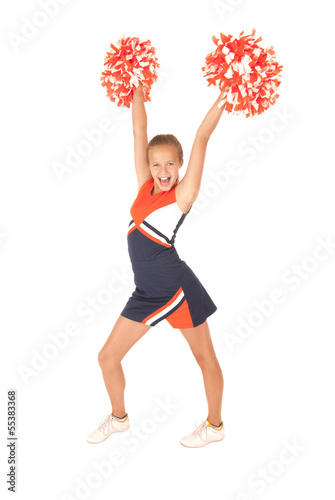 Young girl cheerleading orange pompoms