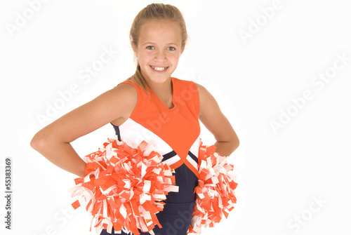 Young girl cheerleader standing with pompoms