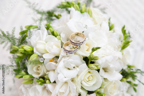 two wedding rings on bridal bouquet
