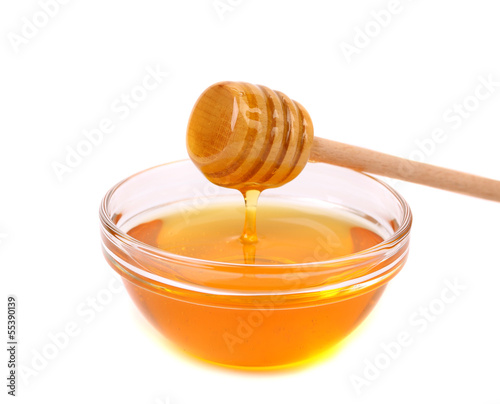 Bow of honey and wooden spoon.